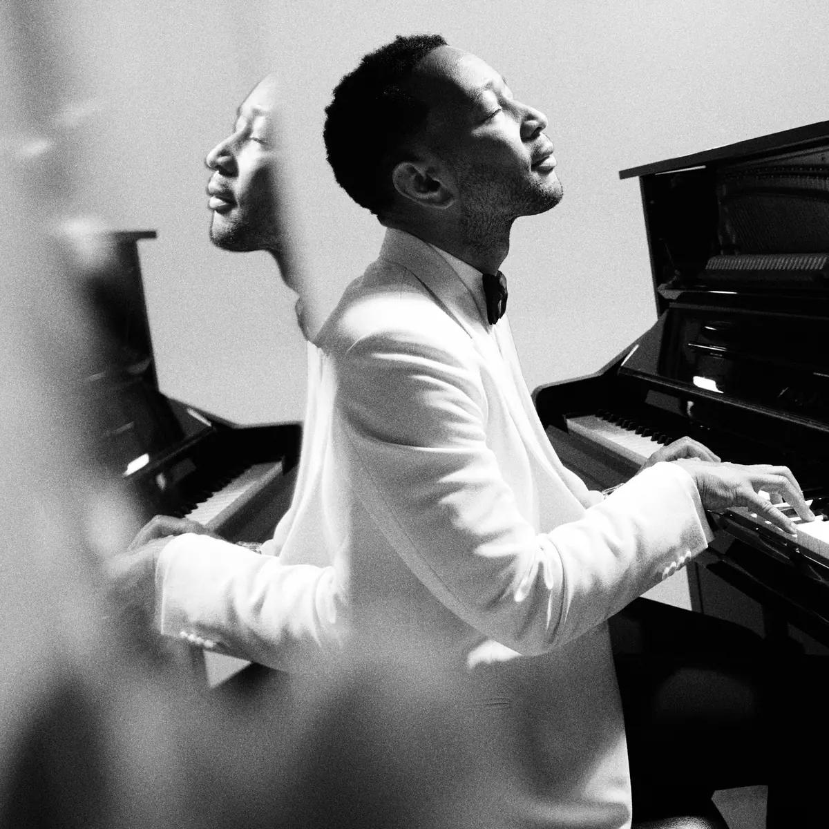 Muse front cover: John Legend at the piano in a white dinner jacket, his face doubled, looking up